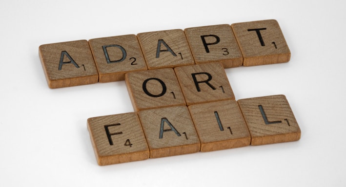 brown wooden letter blocks on white surface