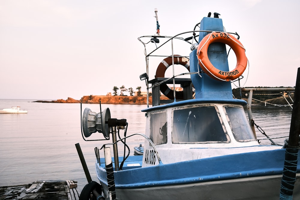 white and blue boat on sea during daytime