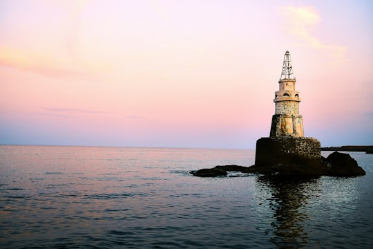 silhouette of tower on rock formation in the middle of sea during daytime in Ahtopol Bulgaria
