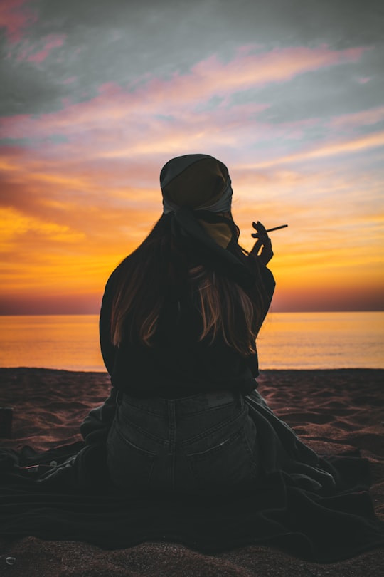 woman in black jacket and black pants standing on beach during sunset in Sozopol Bulgaria