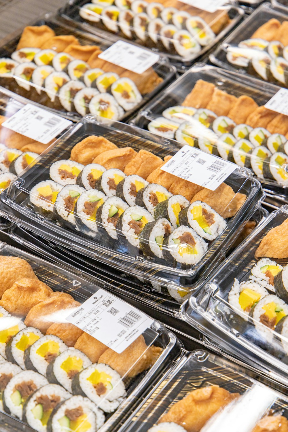 brown and white pastries on clear glass display counter