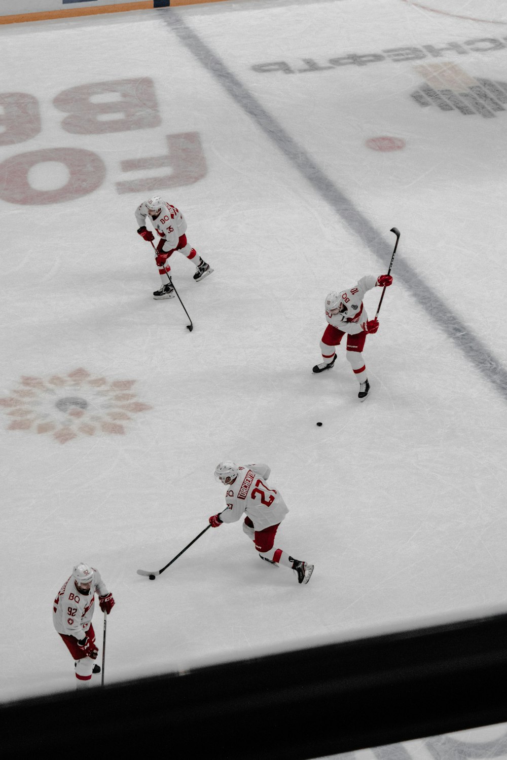 people playing ice hockey on ice field