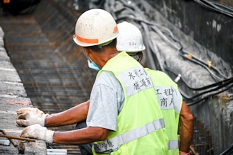 man in white t-shirt wearing orange helmet