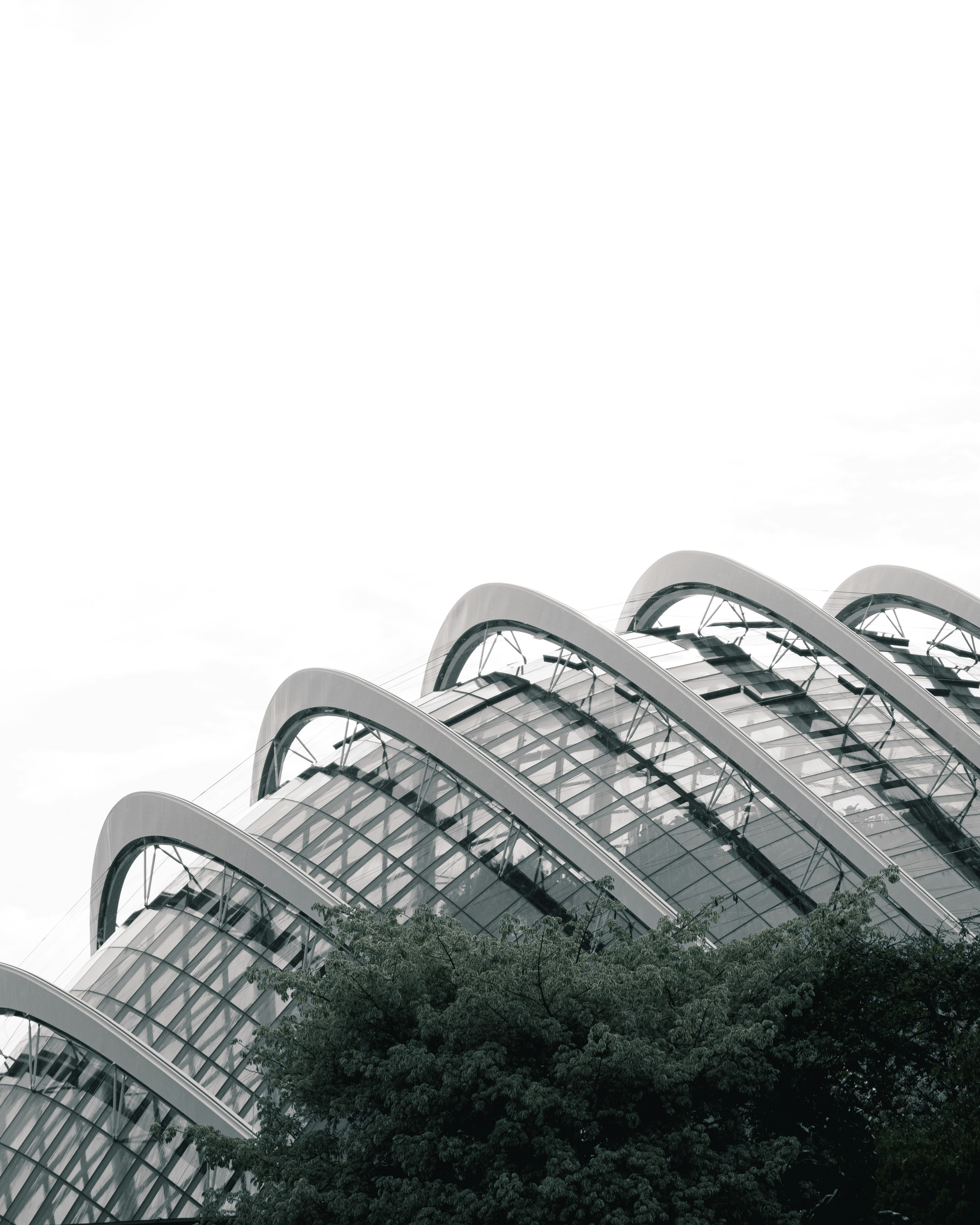 white concrete building near green trees during daytime