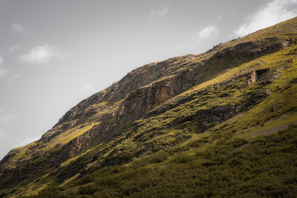 green and brown mountain under white clouds during daytime