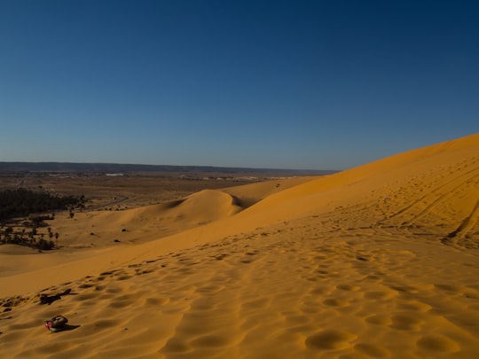 brown sand under blue sky during daytime in Taghit Algeria