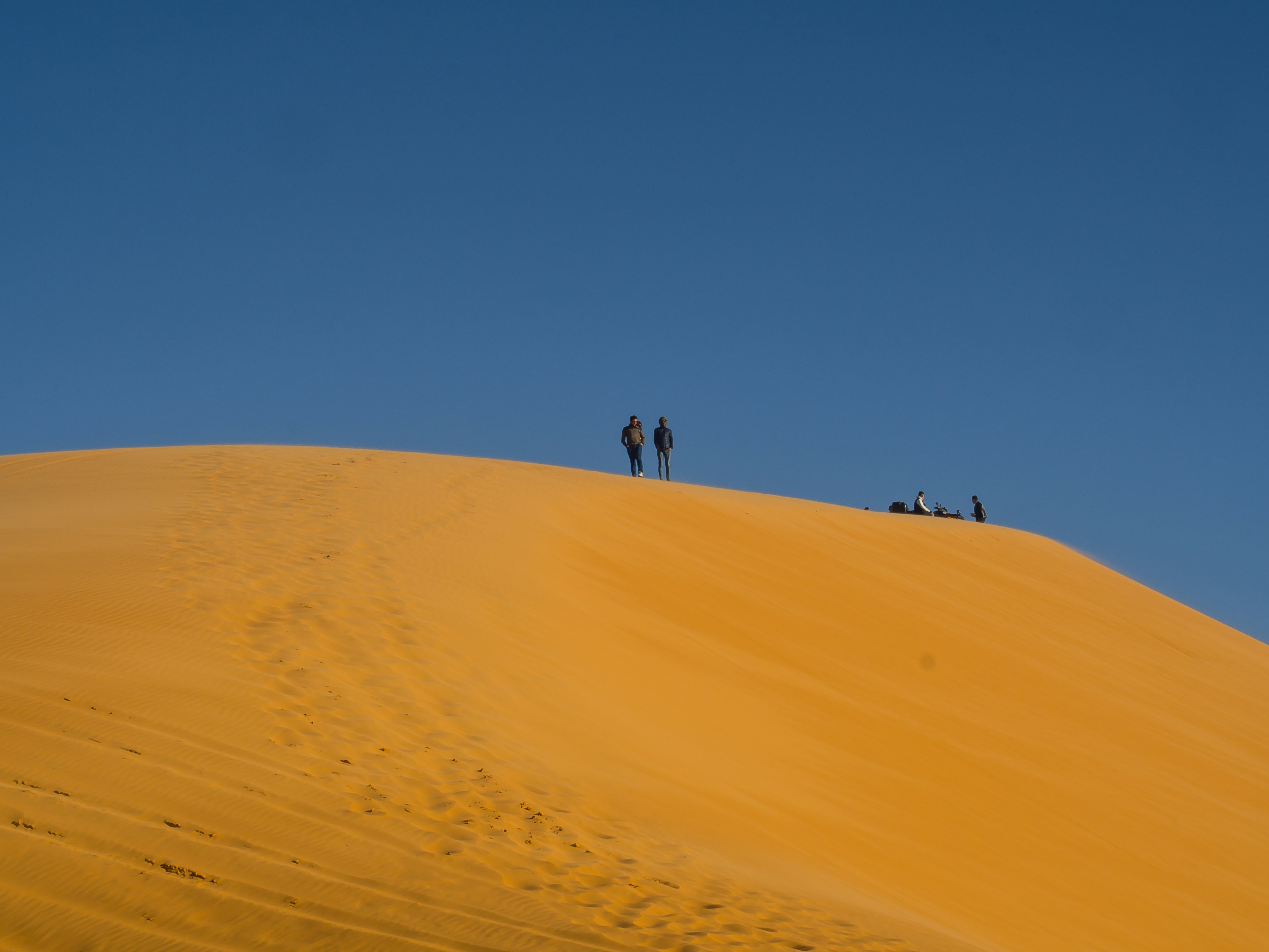 people walking on desert during daytime, 