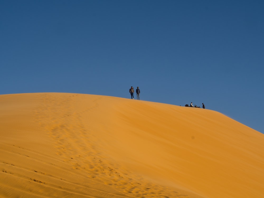 people walking on desert during daytime