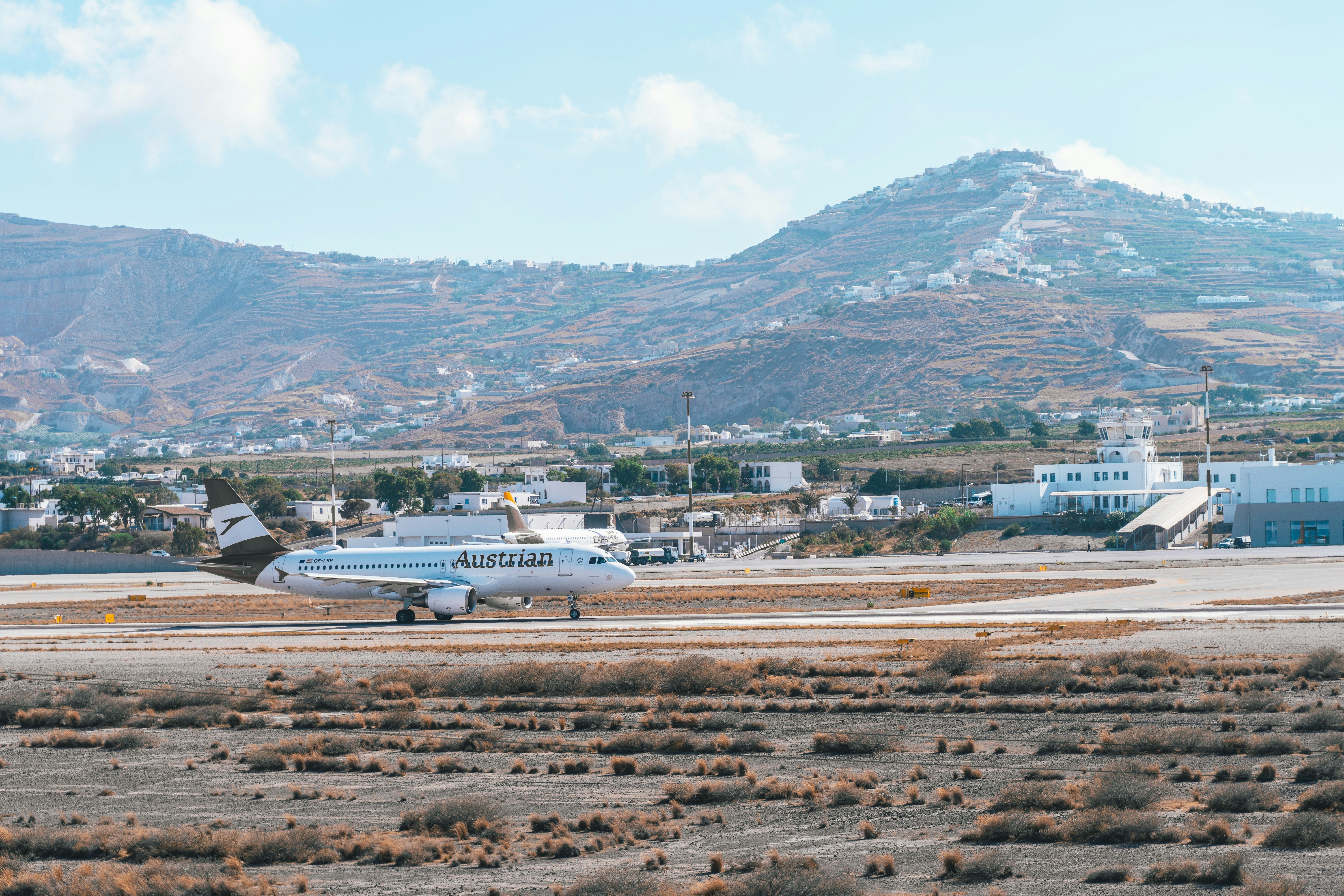 white airplane on brown field during daytime, 