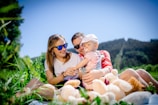 woman in white shirt carrying baby in white and red stripe shirt