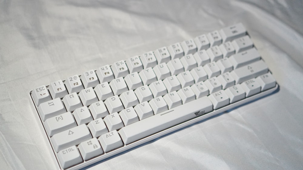 white computer keyboard on white textile