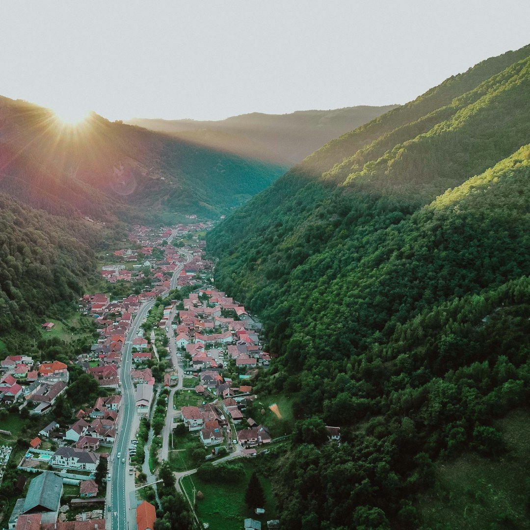 aerial view of city near green mountains during daytime