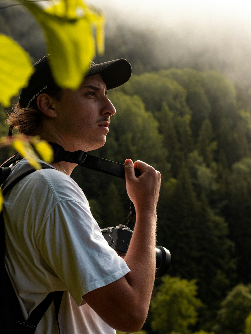 man in white shirt and yellow hat holding black and brown stick