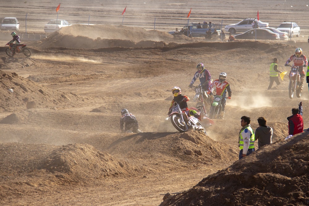 people riding motorcycle on brown dirt road during daytime