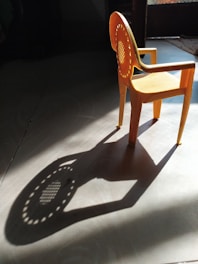 brown plastic armchair on gray floor