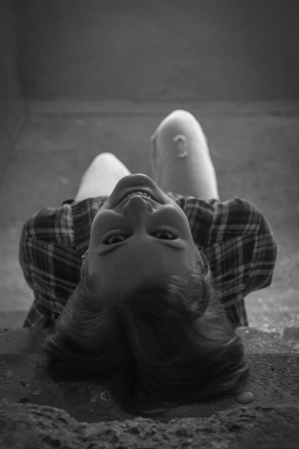 woman in plaid shirt lying on floor