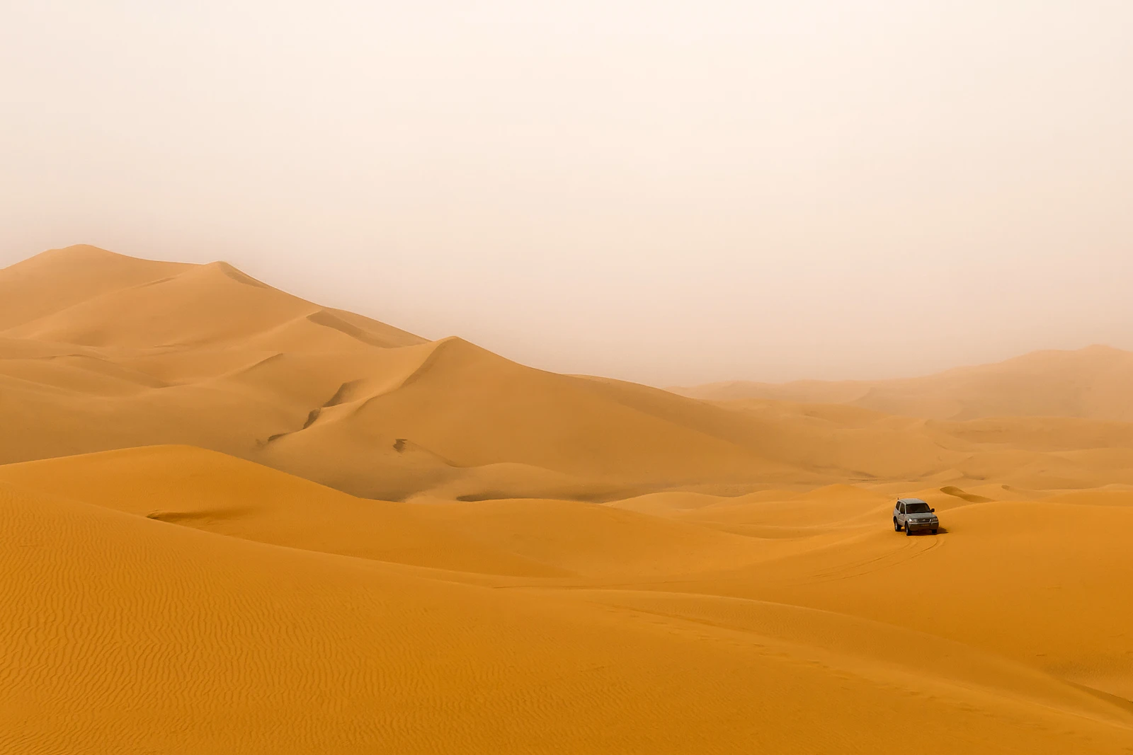 4x4 driving through Sahara dunes
