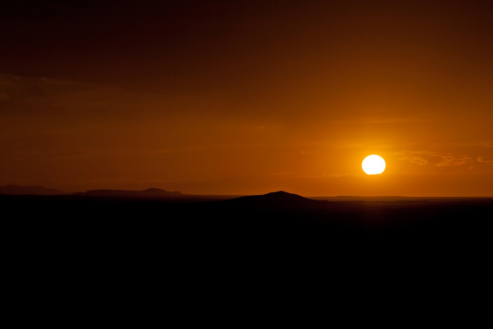 silhouette of mountain during sunset