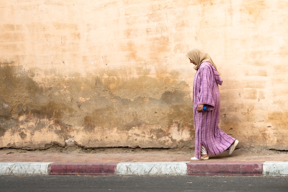woman in purple dress standing on concrete floor