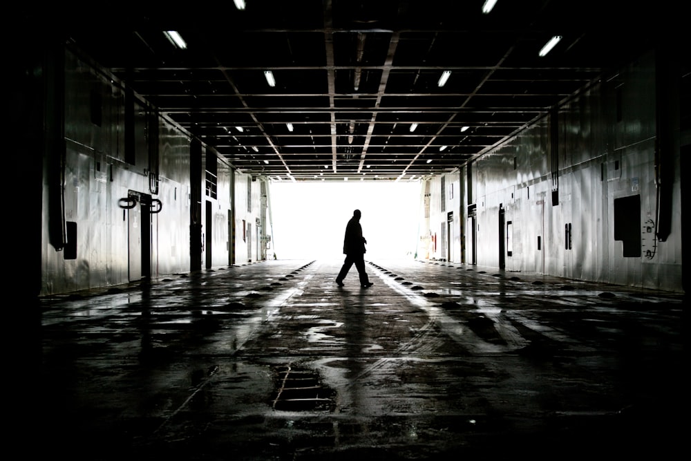 silhouette of person walking on hallway