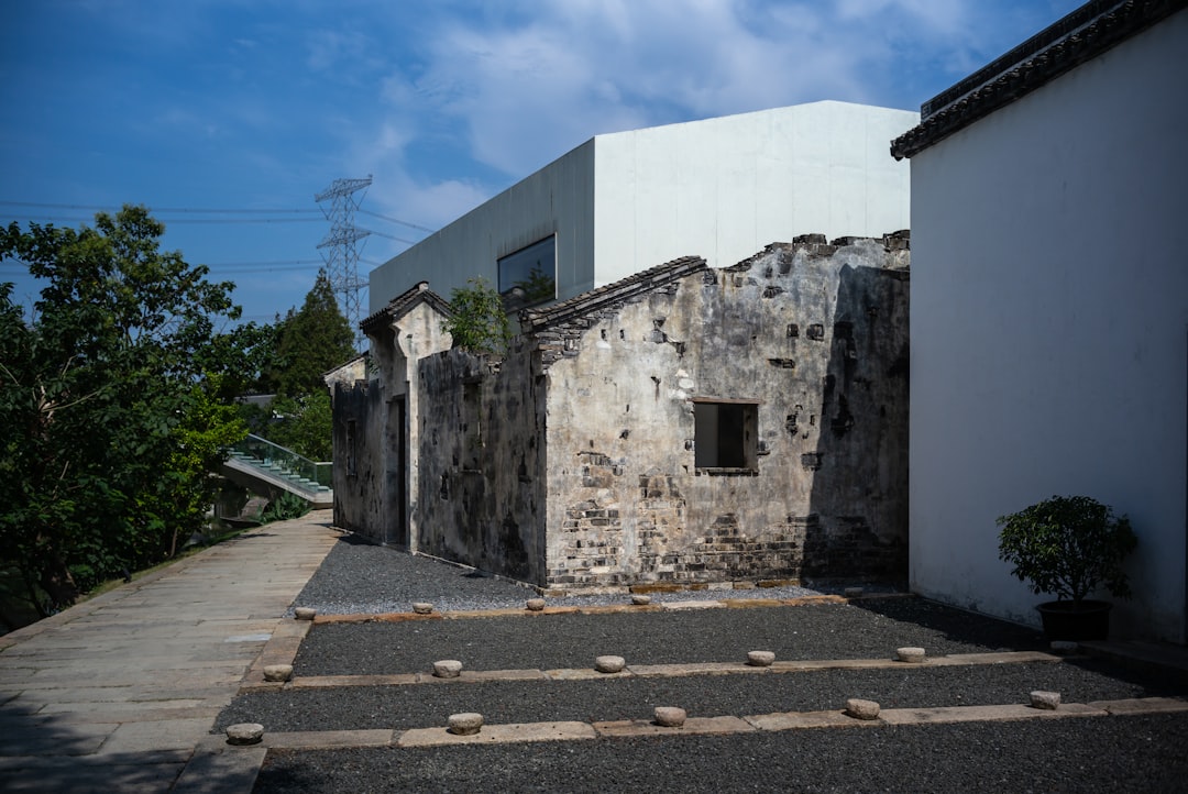 white concrete building near green trees during daytime