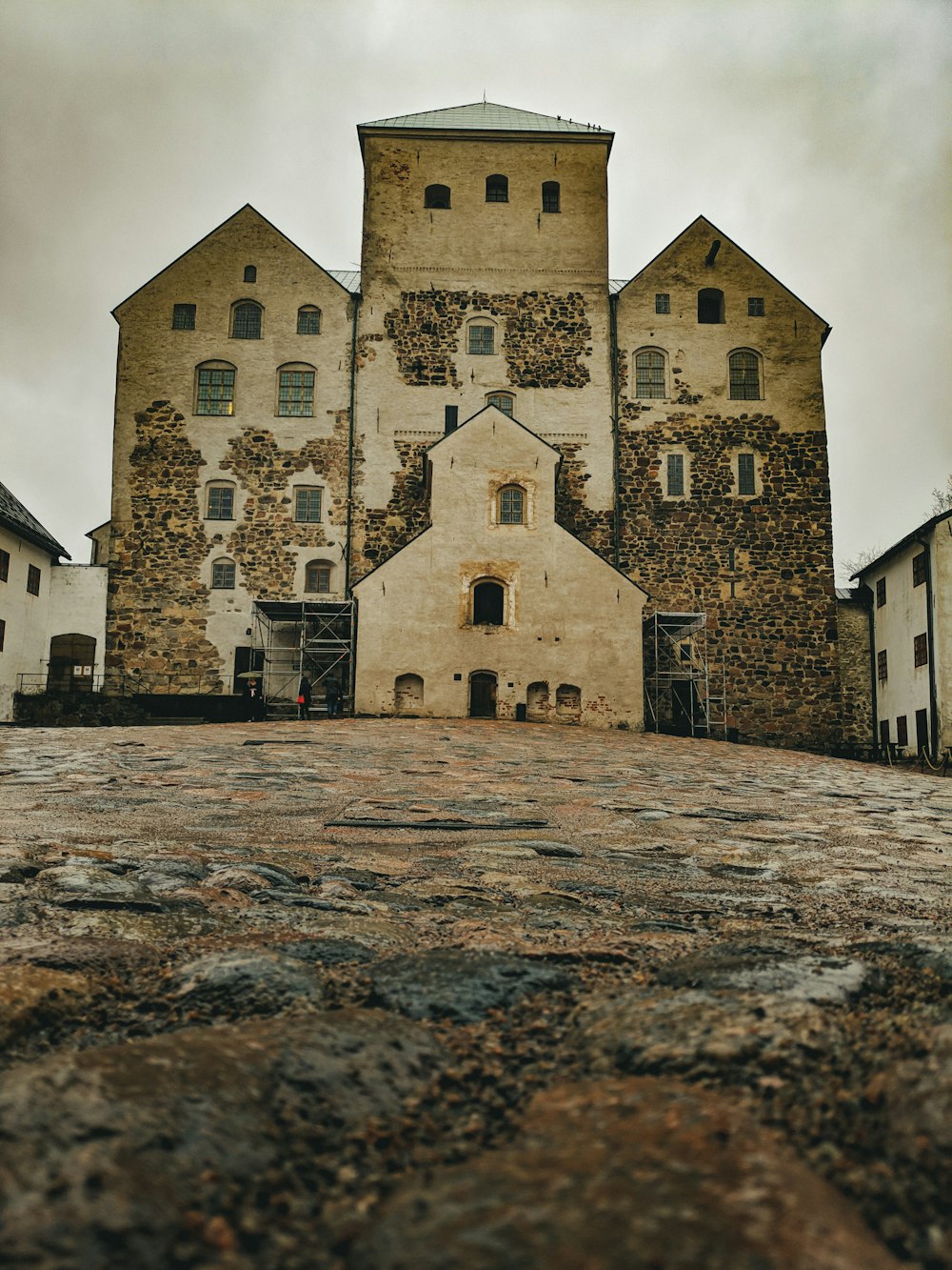 brown brick building under white sky during daytime