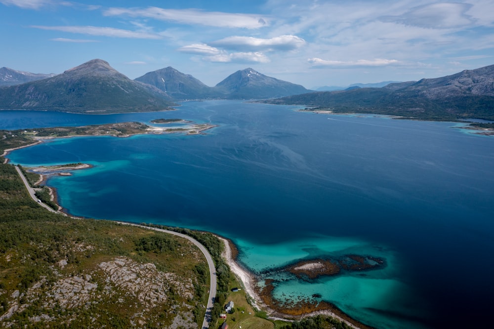 aerial view of blue sea and green mountains during daytime