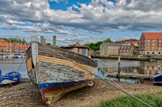 brown and white boat on body of water during daytime