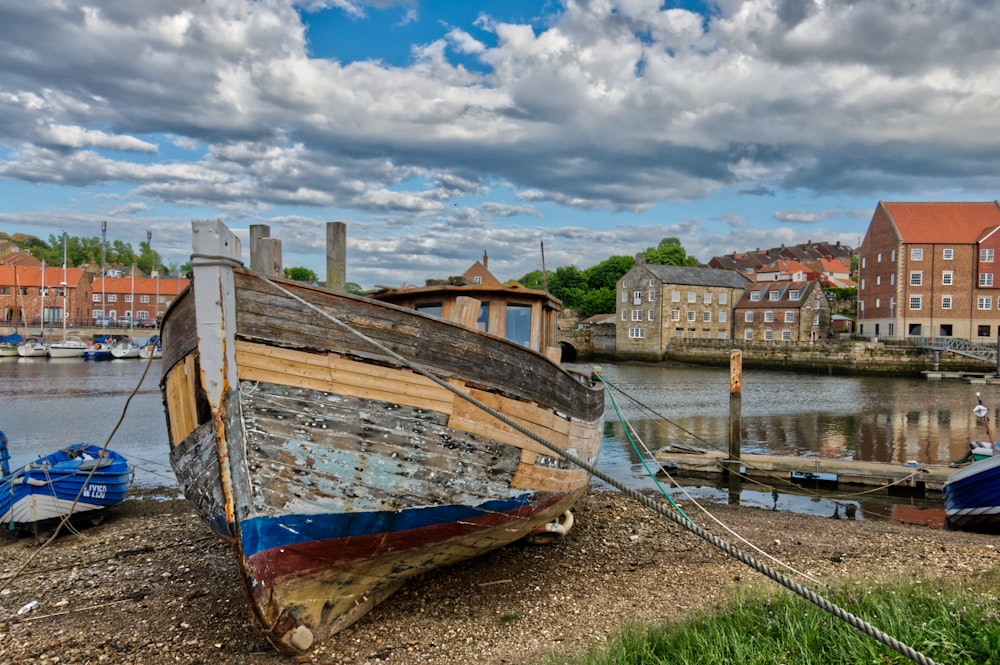 brown and white boat on body of water during daytime