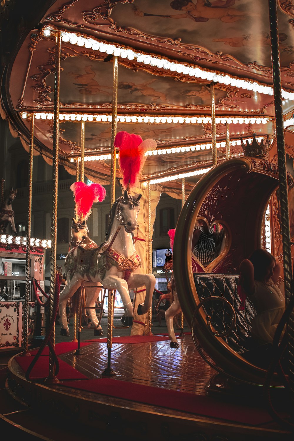 brown horse carousel with people