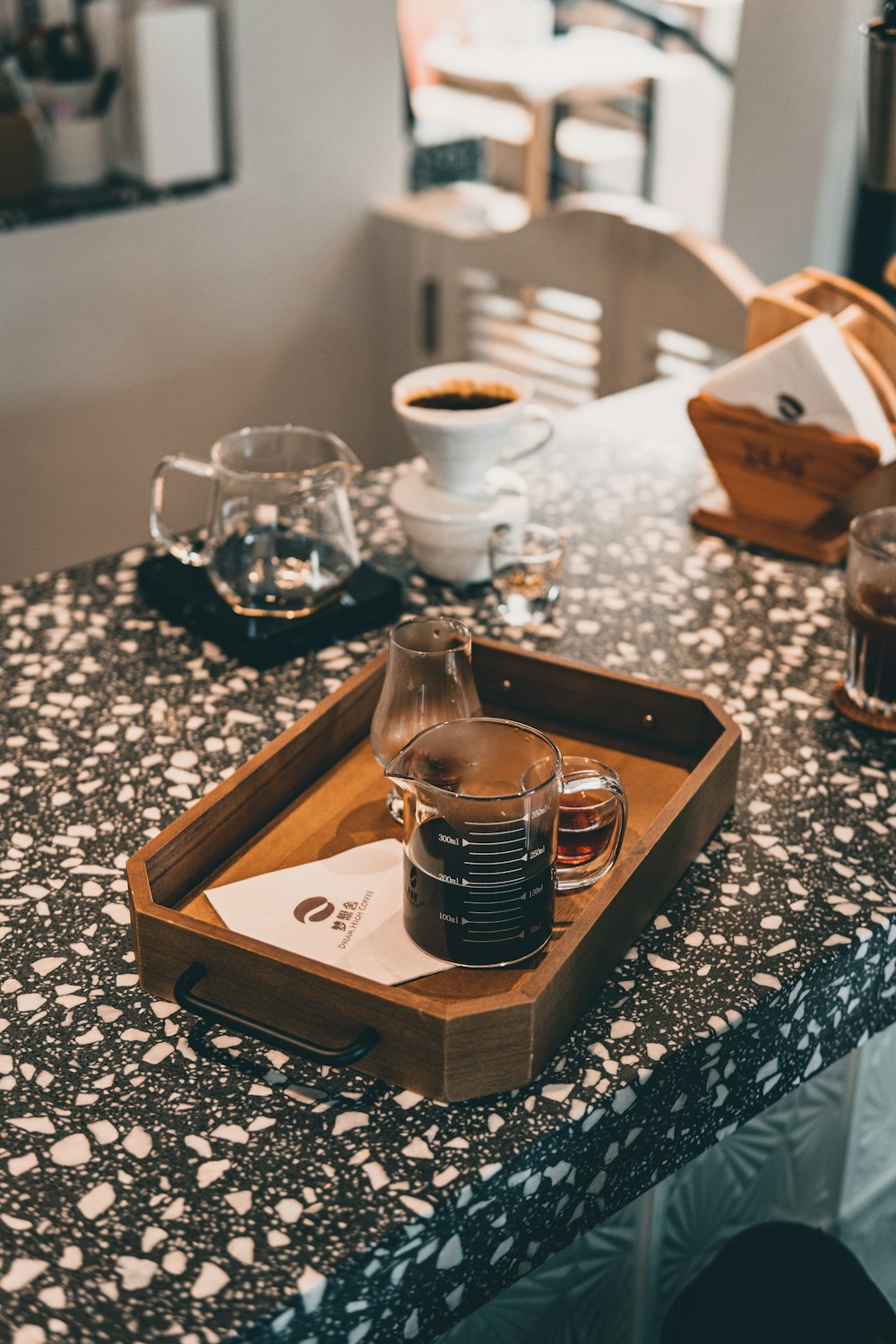 clear glass mug on brown wooden tray