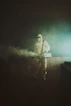 man in black jacket standing on stage
