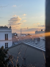 white concrete house near body of water during sunset
