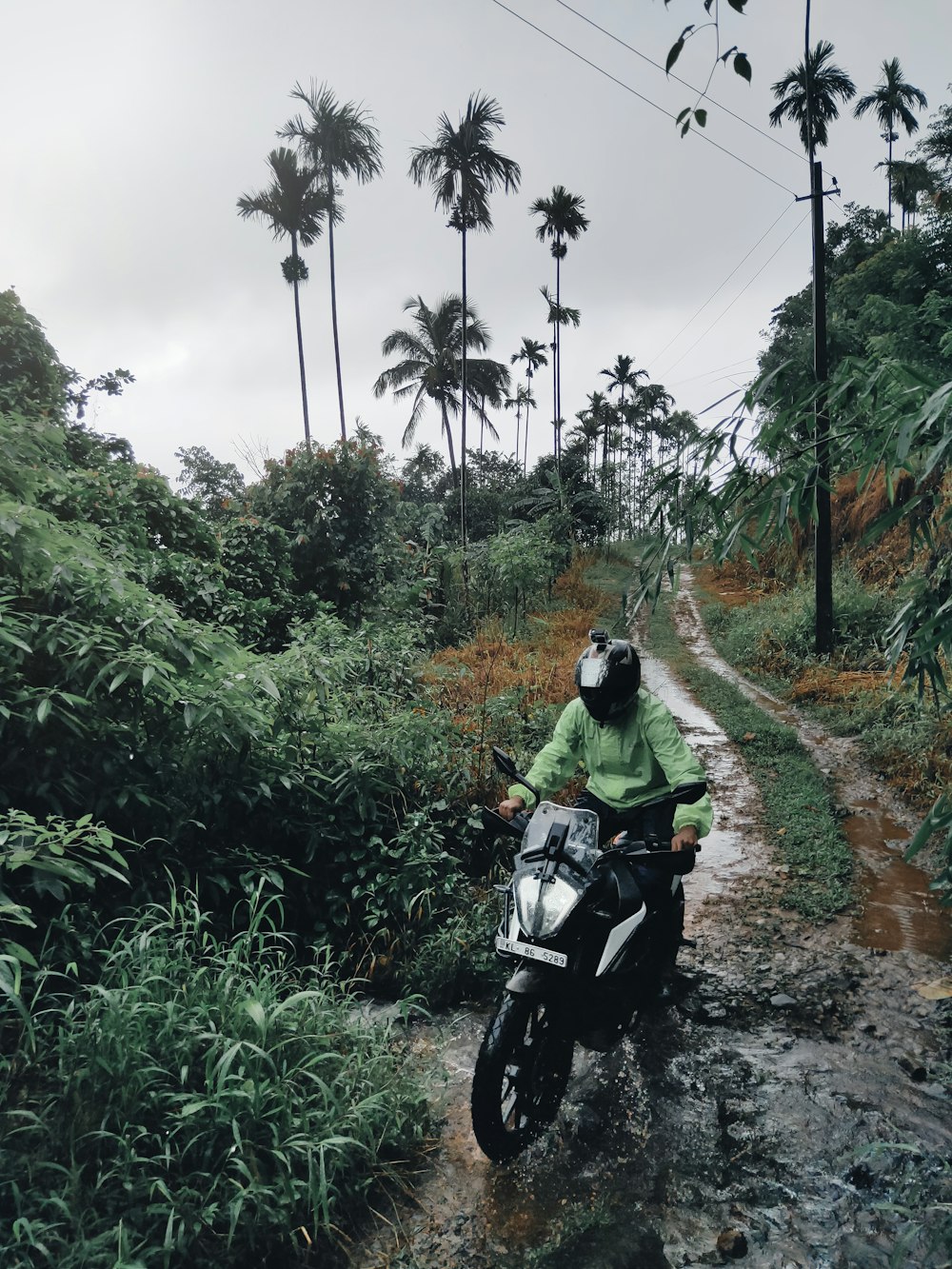 man in black jacket riding motorcycle on dirt road during daytime