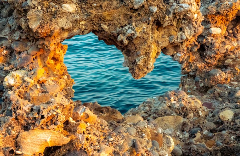 brown rock formation near body of water during daytime