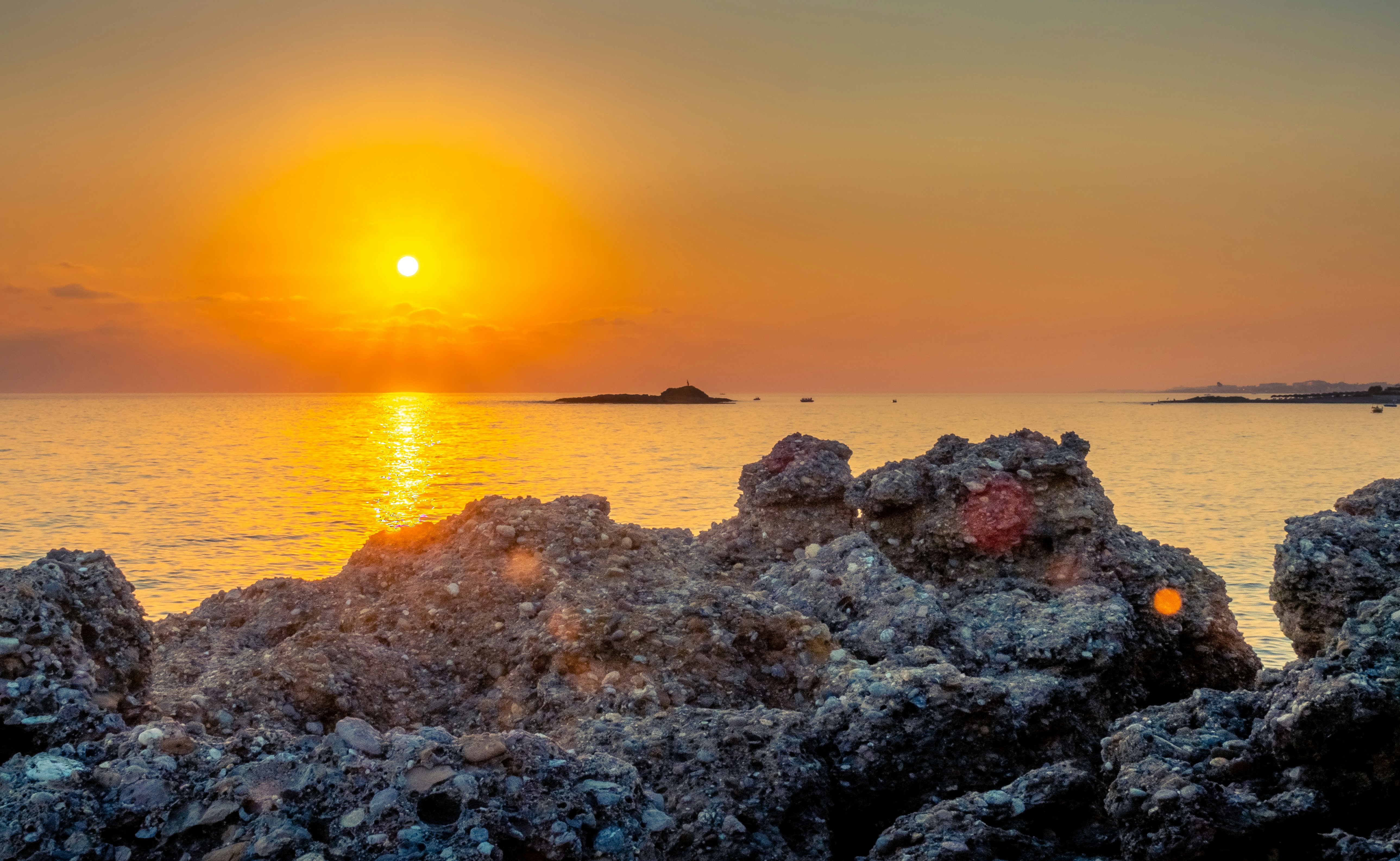 brown rocky shore during sunset