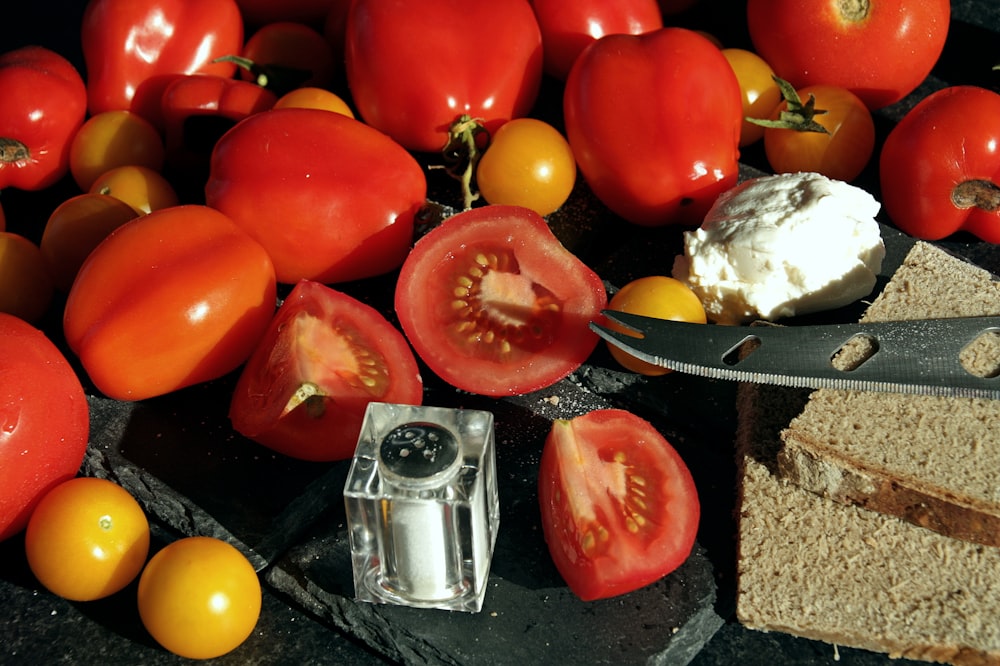 red tomato beside yellow round fruit