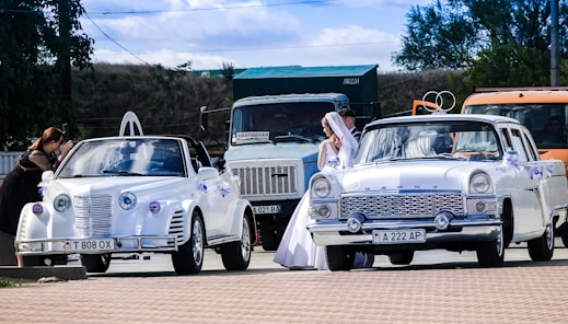 man and woman in white vintage car