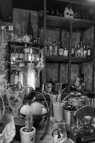 A cozy home bar setup with cocktail tools and ingredients neatly arranged.