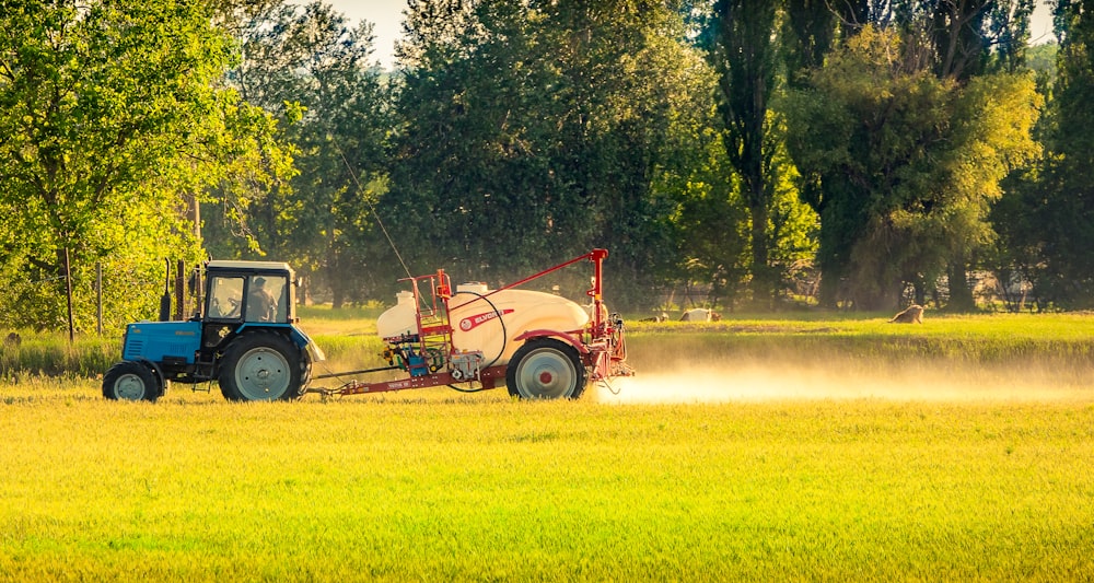 red and black truck on green grass field during daytime