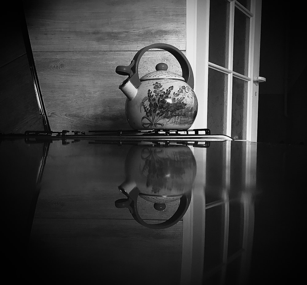 a black and white photo of a tea kettle