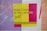 A bold and colorful poster features the phrase 'Build Confidence in the Creative Spirit' in black and yellow text. The background displays vibrant vertical stripes in blue and pink, with contrasting designs in yellow and purple.
