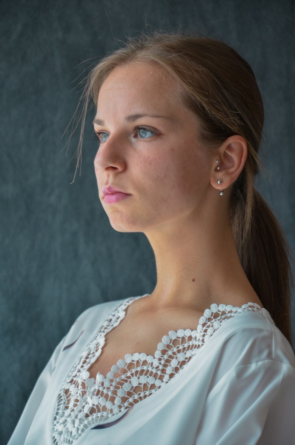 woman in white floral lace shirt