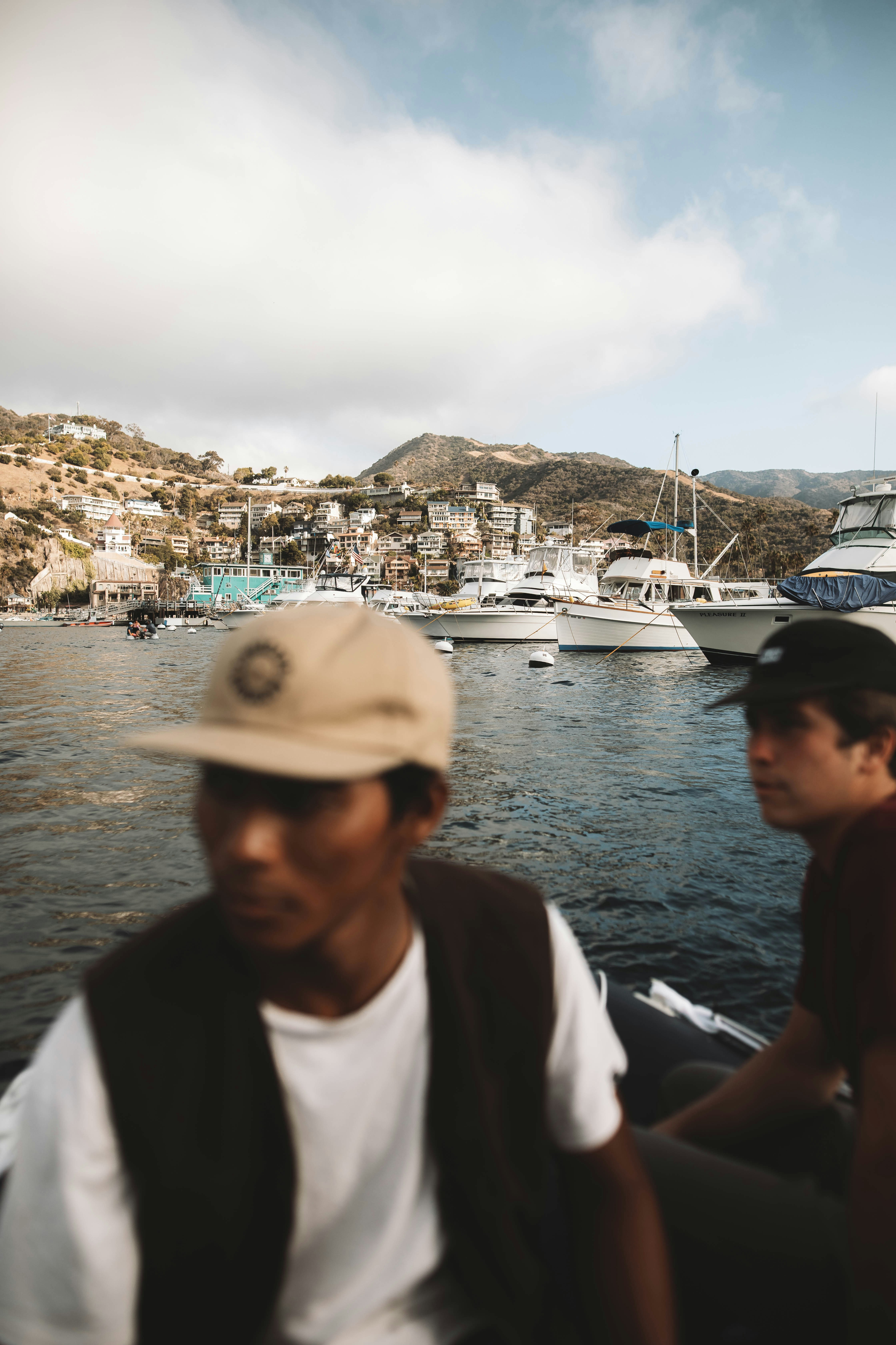 man in white shirt wearing white cap standing beside woman in black shirt