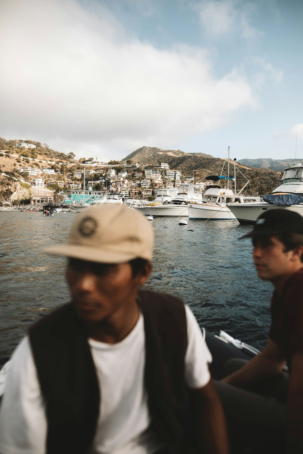 man in white shirt wearing white cap standing beside woman in black shirt