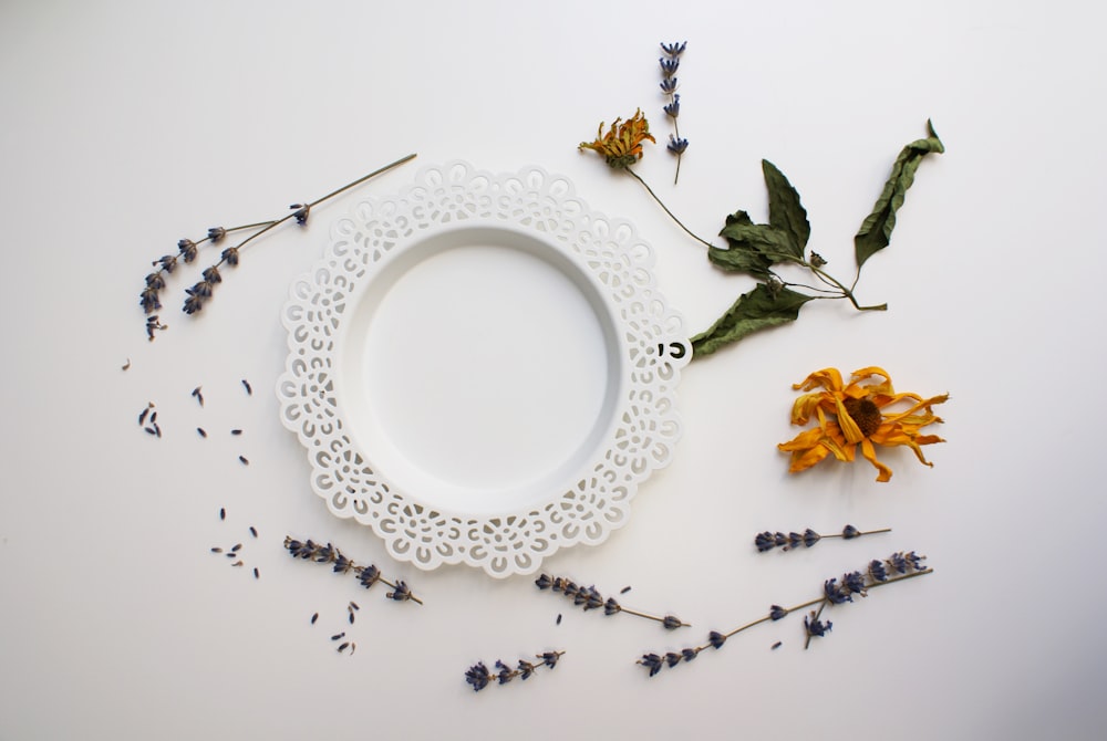 white and blue floral ceramic round plate