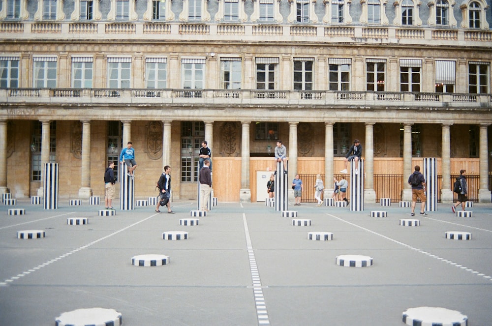 people walking on white concrete building during daytime