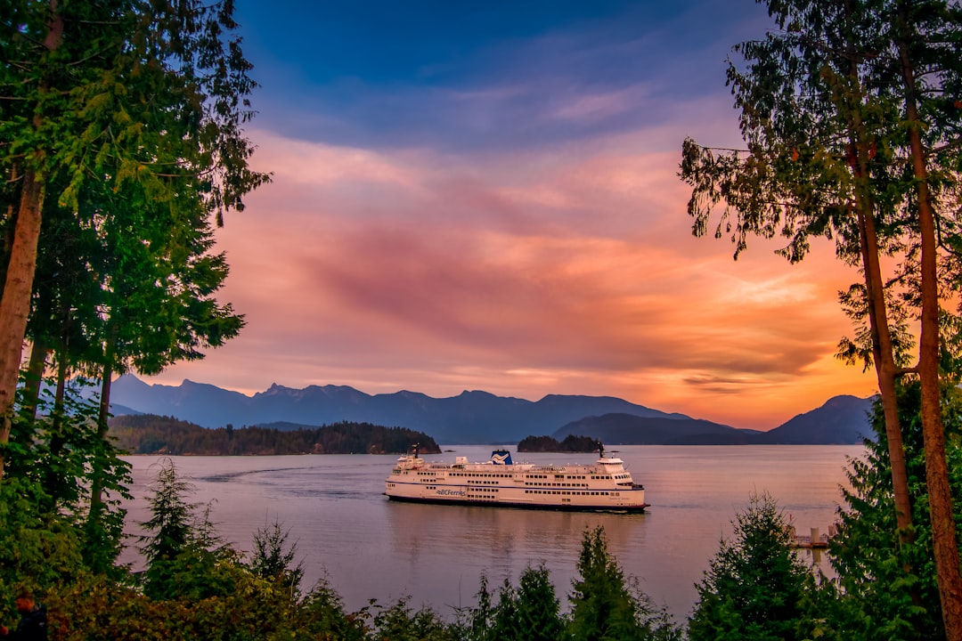 white cruise ship on body of water during sunset