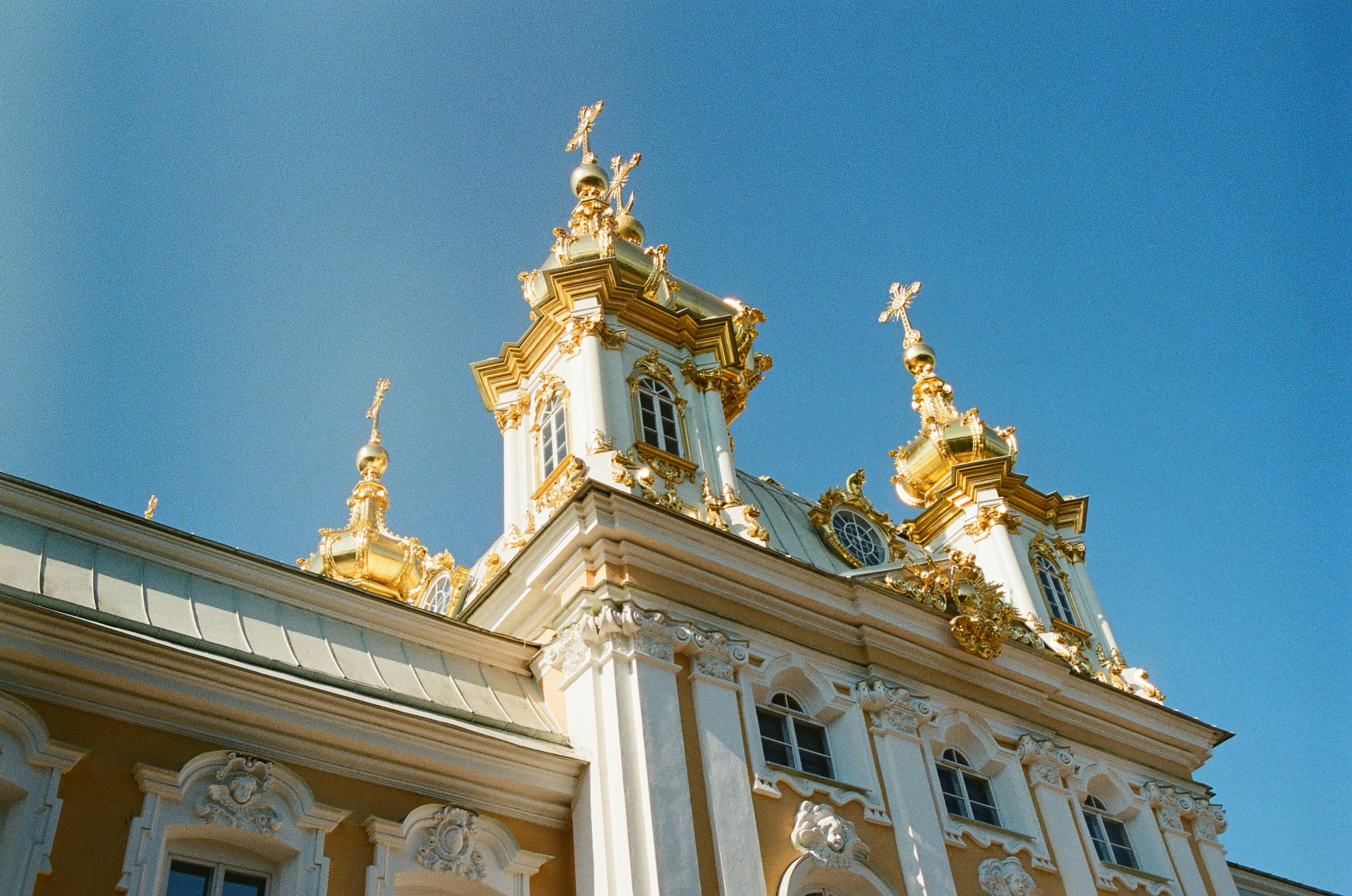 white and gold concrete church under blue sky during daytime