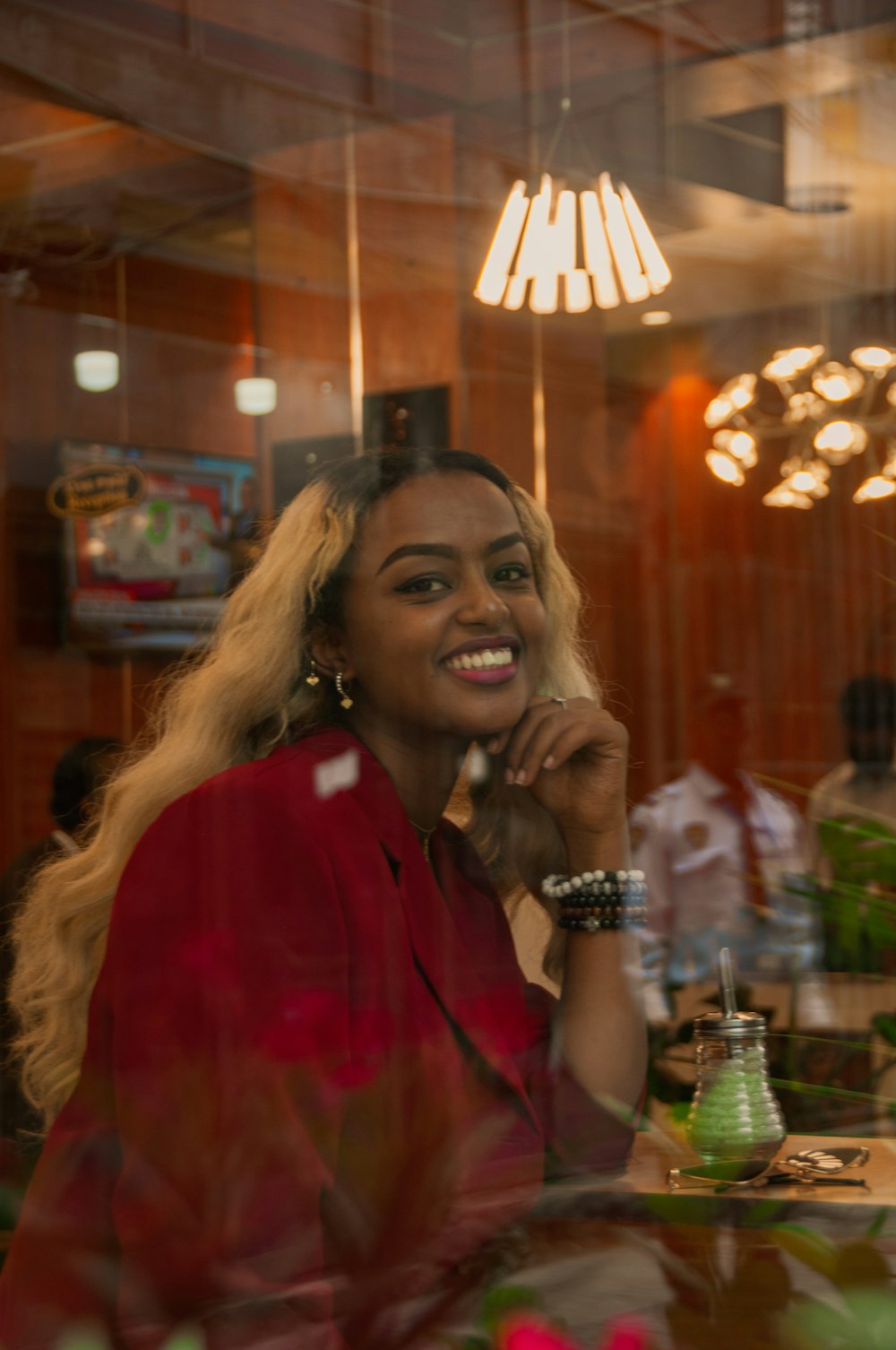 woman in red button up shirt smiling